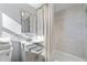Bright bathroom with white shower curtain, updated vanity, and grey tile at 399 W Sandtown Sw Rd, Marietta, GA 30064