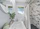 Charming bathroom with marble tiled walls, a decorative mirror, and modern fixtures at 399 W Sandtown Sw Rd, Marietta, GA 30064