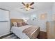 Cozy bedroom features a bed with cushioned headboard, complementary decor, and ceiling fan at 399 W Sandtown Sw Rd, Marietta, GA 30064