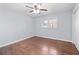 Cozy bedroom featuring a ceiling fan, hardwood flooring, and a window at 399 W Sandtown Sw Rd, Marietta, GA 30064