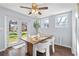 Dining room with a stylish table set and modern chairs next to an outdoor view at 399 W Sandtown Sw Rd, Marietta, GA 30064