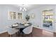 Cozy dining room with a round table, stylish chairs, and a view of the outdoor patio area through a sliding door at 399 W Sandtown Sw Rd, Marietta, GA 30064
