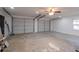 Spacious two-car garage featuring bright lighting and a ceiling fan at 399 W Sandtown Sw Rd, Marietta, GA 30064