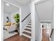 Hallway with a view of the living room and staircase, featuring hardwood floors and neutral wall colors at 399 W Sandtown Sw Rd, Marietta, GA 30064