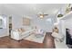 Cozy living room with ceiling fan, fireplace, and a comfortable white sectional sofa at 399 W Sandtown Sw Rd, Marietta, GA 30064