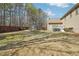 A spacious backyard including a trampoline, patio with grill, and a tall wooden fence at 4020 Inman Park Lane, Buford, GA 30519