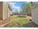 Large grassy backyard featuring a trampoline and storage building, perfect for outdoor activities at 4020 Inman Park Lane, Buford, GA 30519