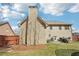 A backyard featuring an outdoor seating area, a grill, and a tall brick chimney at 4020 Inman Park Lane, Buford, GA 30519