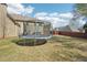 A spacious backyard with a trampoline, offering ample room for outdoor activities at 4020 Inman Park Lane, Buford, GA 30519