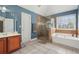 Well-appointed bathroom with a soaking tub, glass shower, and warm tile flooring, creating a spa-like oasis at 4020 Inman Park Lane, Buford, GA 30519