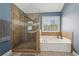 A bathroom boasting a glass shower and a separate white soaking tub at 4020 Inman Park Lane, Buford, GA 30519