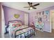 Comfortable bedroom featuring light purple walls, natural light from dual windows, with neutral carpet, and a ceiling fan at 4020 Inman Park Lane, Buford, GA 30519