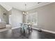 Bright dining area with dark wood floors adjacent to a living room with high ceilings and fireplace at 4020 Inman Park Lane, Buford, GA 30519