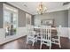 Formal dining room featuring rich wood flooring, white wainscoting and stylish lighting fixture at 4020 Inman Park Lane, Buford, GA 30519