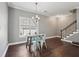 Cozy dining area featuring hardwood floors, a pendant light fixture and access to the stairs at 4020 Inman Park Lane, Buford, GA 30519