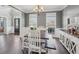 Open dining area with hardwood floors, decorative sideboard, and access to the kitchen at 4020 Inman Park Lane, Buford, GA 30519