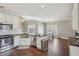 This spacious kitchen features white cabinets, stainless steel appliances, and a seating area at 4020 Inman Park Lane, Buford, GA 30519