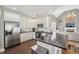 Bright kitchen features white cabinets, stainless steel appliances, island, and dark countertops at 4020 Inman Park Lane, Buford, GA 30519