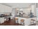 The kitchen features white cabinets, stainless steel appliances, and a center island with seating at 4020 Inman Park Lane, Buford, GA 30519