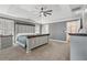 Spacious main bedroom with tray ceiling, plush carpeting, and a large bed, offering a serene and luxurious retreat at 4020 Inman Park Lane, Buford, GA 30519