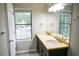 Bathroom featuring double sinks with a large mirror and a window view at 811 Heritage Valley Rd, Norcross, GA 30093