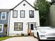 Charming home featuring a white facade with black trim and a modern white car in the driveway at 811 Heritage Valley Rd, Norcross, GA 30093