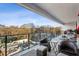 Relaxing covered balcony with wicker furniture and a view of lush greenery at 2520 Peachtree Rd # 602, Atlanta, GA 30305