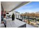 Inviting balcony with a dining table and lounge area offering serene views of the landscape at 2520 Peachtree Rd # 602, Atlanta, GA 30305