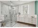 Contemporary bathroom featuring a glass-enclosed shower, marble tile, and a white vanity with bright mirror at 2520 Peachtree Rd # 602, Atlanta, GA 30305