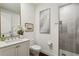 Modern bathroom featuring white cabinets, quartz counters, framed art, and a glass-enclosed shower at 2520 Peachtree Rd # 602, Atlanta, GA 30305