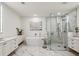 Bright bathroom with a freestanding tub, glass-enclosed shower, marble floors, and dual vanity sinks at 2520 Peachtree Rd # 602, Atlanta, GA 30305