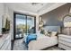 Well-lit bedroom with hardwood floors, a tray ceiling, balcony access and stylish contemporary decor at 2520 Peachtree Rd # 602, Atlanta, GA 30305