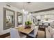 Open dining room with hardwood floors and modern lighting adjacent to the gourmet kitchen at 2520 Peachtree Rd # 602, Atlanta, GA 30305