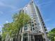 Modern condo building featuring balconies and large windows, surrounded by mature trees at 2520 Peachtree Rd # 602, Atlanta, GA 30305