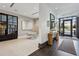 Hallway with tiled floors, console table, and glass door that leads to community area at 2520 Peachtree Rd # 602, Atlanta, GA 30305