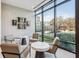 Community lounge with large windows, modern furnishings, and view of the outdoor amenities at 2520 Peachtree Rd # 602, Atlanta, GA 30305