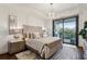 Main bedroom featuring a decorative light fixture, a large bed, and a walkout balcony at 2520 Peachtree Rd # 602, Atlanta, GA 30305