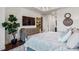 Bright main bedroom featuring a stylish dresser, contemporary lighting and a view into the hallway at 2520 Peachtree Rd # 602, Atlanta, GA 30305