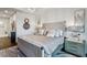 Well-lit main bedroom with a large bed, wood floors, and access to the ensuite bathroom with soaking tub at 2520 Peachtree Rd # 602, Atlanta, GA 30305