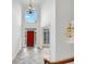 Grand foyer with a soaring ceiling, decorative chandelier, and bright red front door at 3083 Milledge Gate Se Ct, Marietta, GA 30067