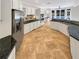 Spacious kitchen featuring a breakfast bar, tile floors, granite countertops, and stainless steel appliances at 3083 Milledge Gate Se Ct, Marietta, GA 30067