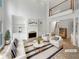 Bright living room with fireplace, built-in bookshelves, soaring ceilings, and a view to the second level at 3083 Milledge Gate Se Ct, Marietta, GA 30067