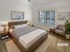 Inviting bedroom with a large bed, stylish furniture, and plantation shutters for a modern aesthetic at 3083 Milledge Gate Se Ct, Marietta, GA 30067