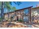 Beautiful two-story brick townhouse featuring dark shutters, mature landscaping, and a cozy front entrance at 748 Garden View Dr, Stone Mountain, GA 30083