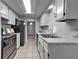 Modern kitchen features stainless appliances, white cabinets, marble countertops, and sleek tile flooring at 748 Garden View Dr, Stone Mountain, GA 30083