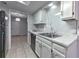 The kitchen has white cabinetry, marble countertops and backsplash, and stainless steel appliances at 748 Garden View Dr, Stone Mountain, GA 30083