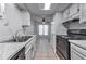 Kitchen showcasing white cabinets, marble countertops, stainless steel appliances, and tiled floors at 748 Garden View Dr, Stone Mountain, GA 30083