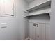 Bright laundry room with white shelving and space for appliances at 748 Garden View Dr, Stone Mountain, GA 30083