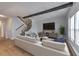 Bright living room featuring modern furnishings, a staircase, and views of the surrounding landscape at 748 Garden View Dr, Stone Mountain, GA 30083