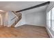 Bright living room featuring hardwood floors, staircase, beam and large windows at 748 Garden View Dr, Stone Mountain, GA 30083